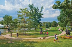 People stroll the grounds of Benson Sculpture Garden.