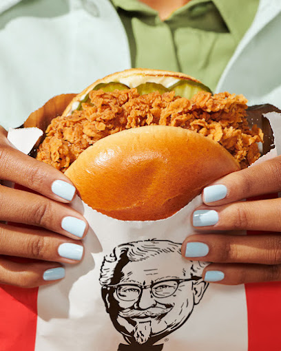 A woman holding a chicken sandwich