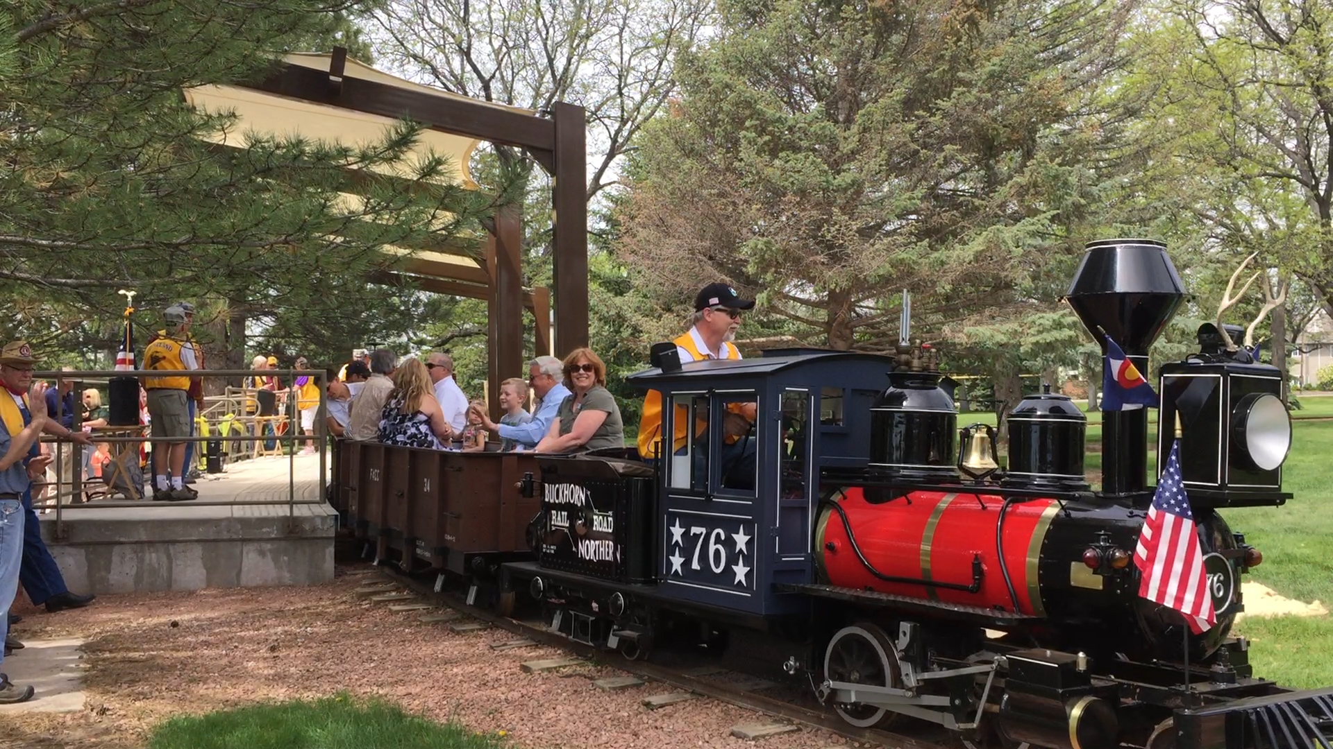 The Buckhorn Northern Railway train sits at the platform in North Lake Park while passengers load.