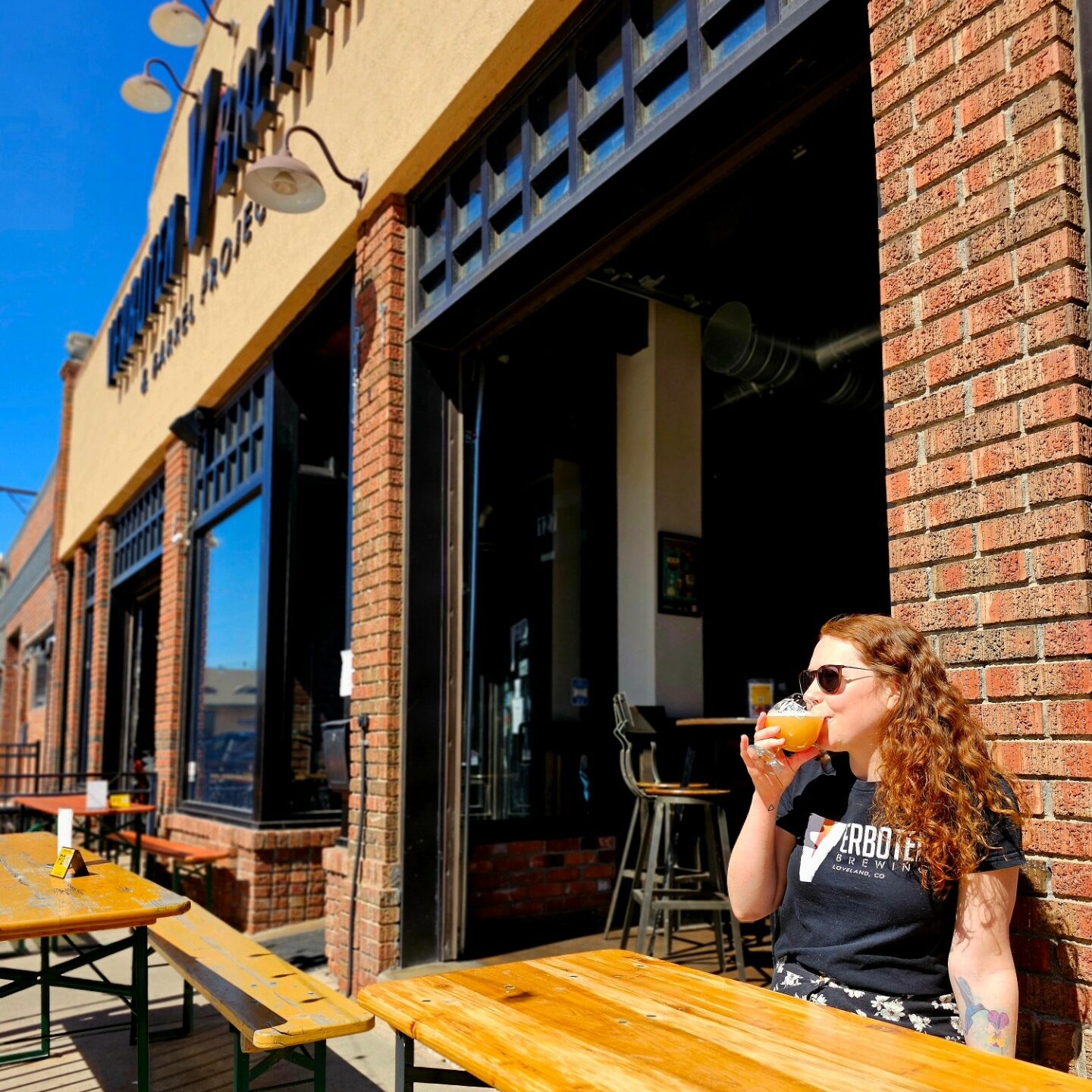 A woman sips a beer on the patio at Verboten Brewing.