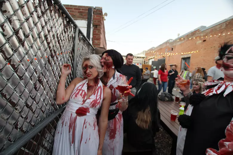 People dressed as zombies walk through downtown Loveland