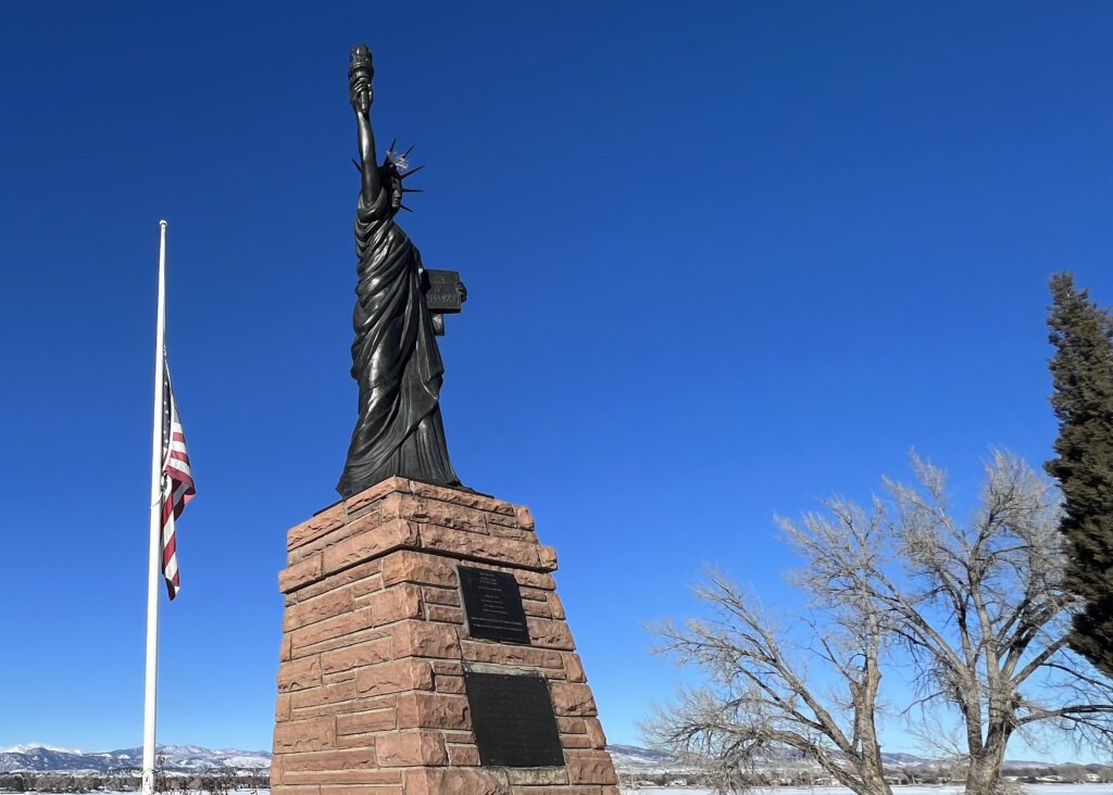 A replica sculpture of the Statue of Liberty sits across from Lake Loveland