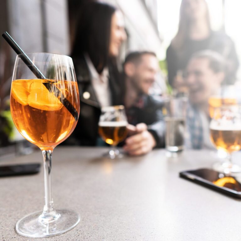 A drink sits on a table on an outdoor patio.