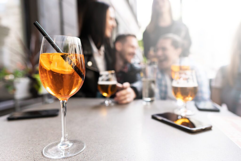 Friends enjoy drinks on a patio.