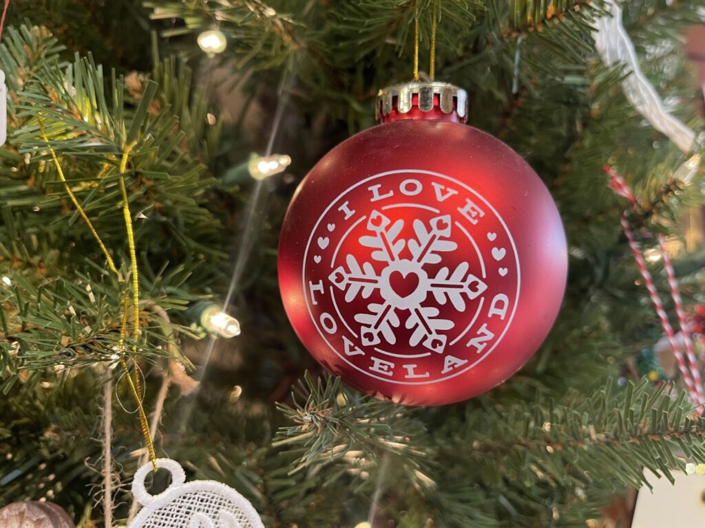 A red "I love Loveland" ornament hangs in a christmas tree.