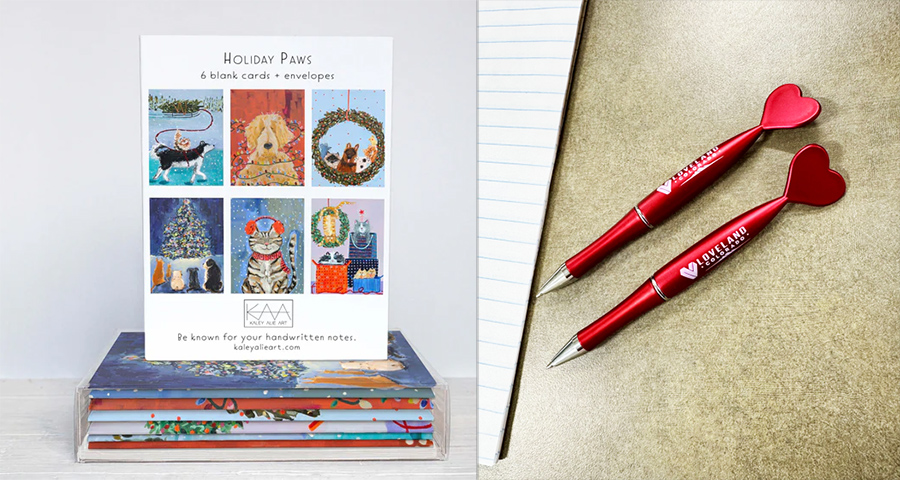 Holiday Paws Greeting cards and Loveland heart pens on a table