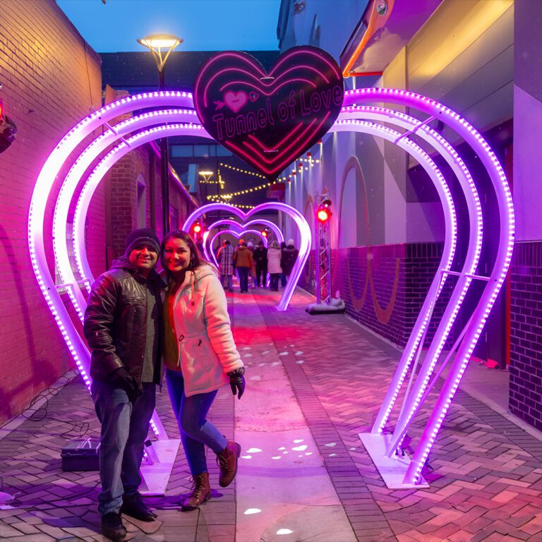 A couple stands in the Tunnel of Love at the 2024 Loveland Sweetheart Festival.