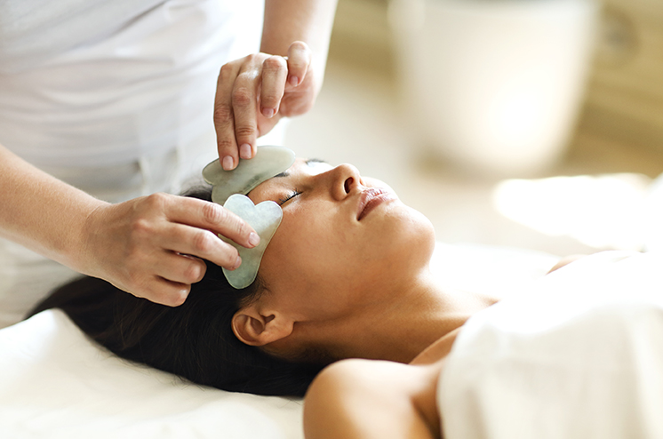 A woman enjoys a face massage