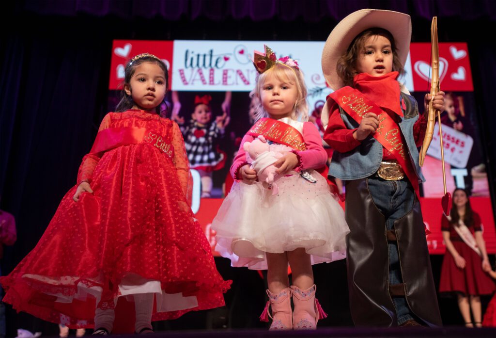 Three children dressed up for Valentine's Day contest.