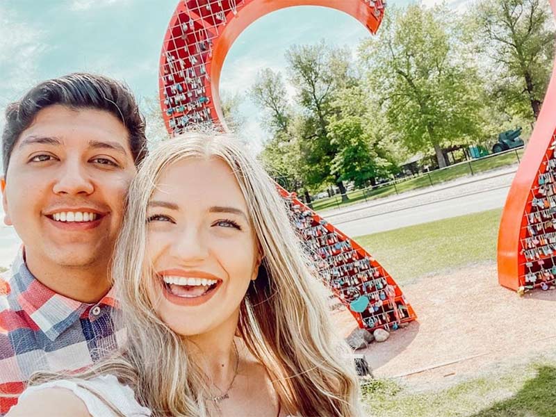 Couple posing in front of Loveland, Colorado's Love Lock Sculpture