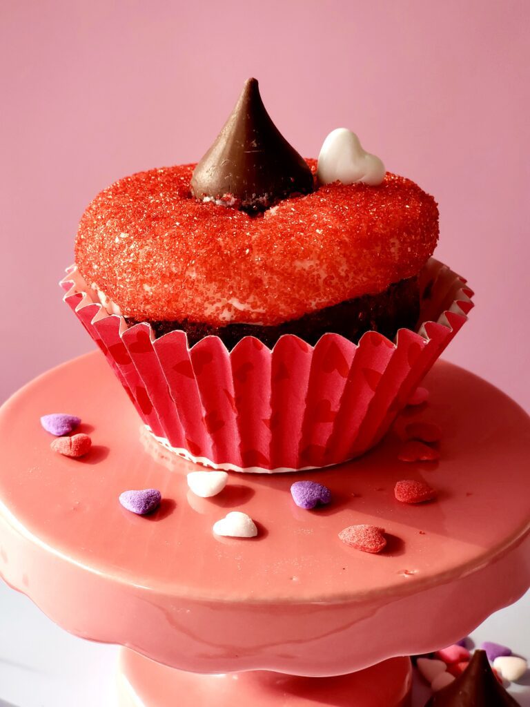 B Sweet Cupcakes' Red Velvet Kiss cupcake on a round cucpcake display.