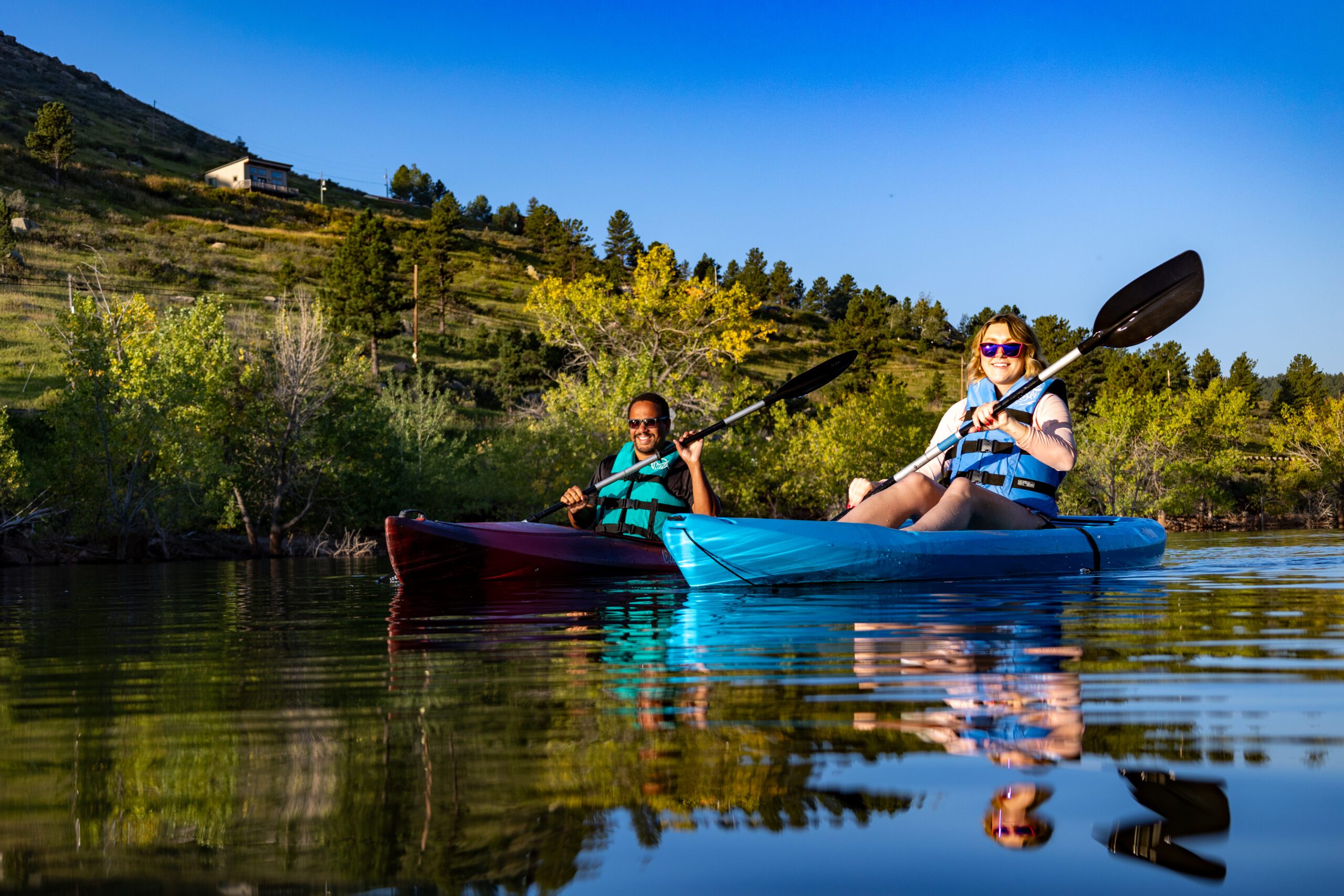 Kayakers enjoy a summer day on Carter Lake in Loveland, Colorado