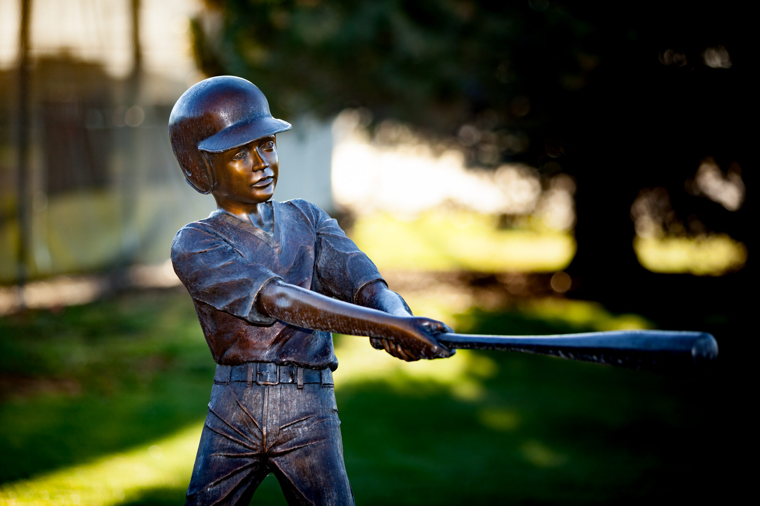 Sculpture of child swinging a baseball bat