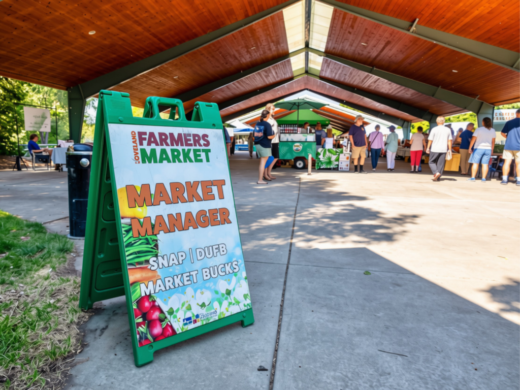 Loveland Farmers Market sign welcoming visitors to explore local vendors and seasonal goods