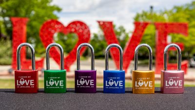 Loveland Love Locks sit in a row in front of the Loveland Love Lock Sculpture.