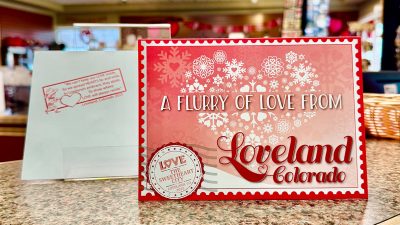 The 2025 Loveland Valentine Card sits on display at the Loveland Visitors Center.